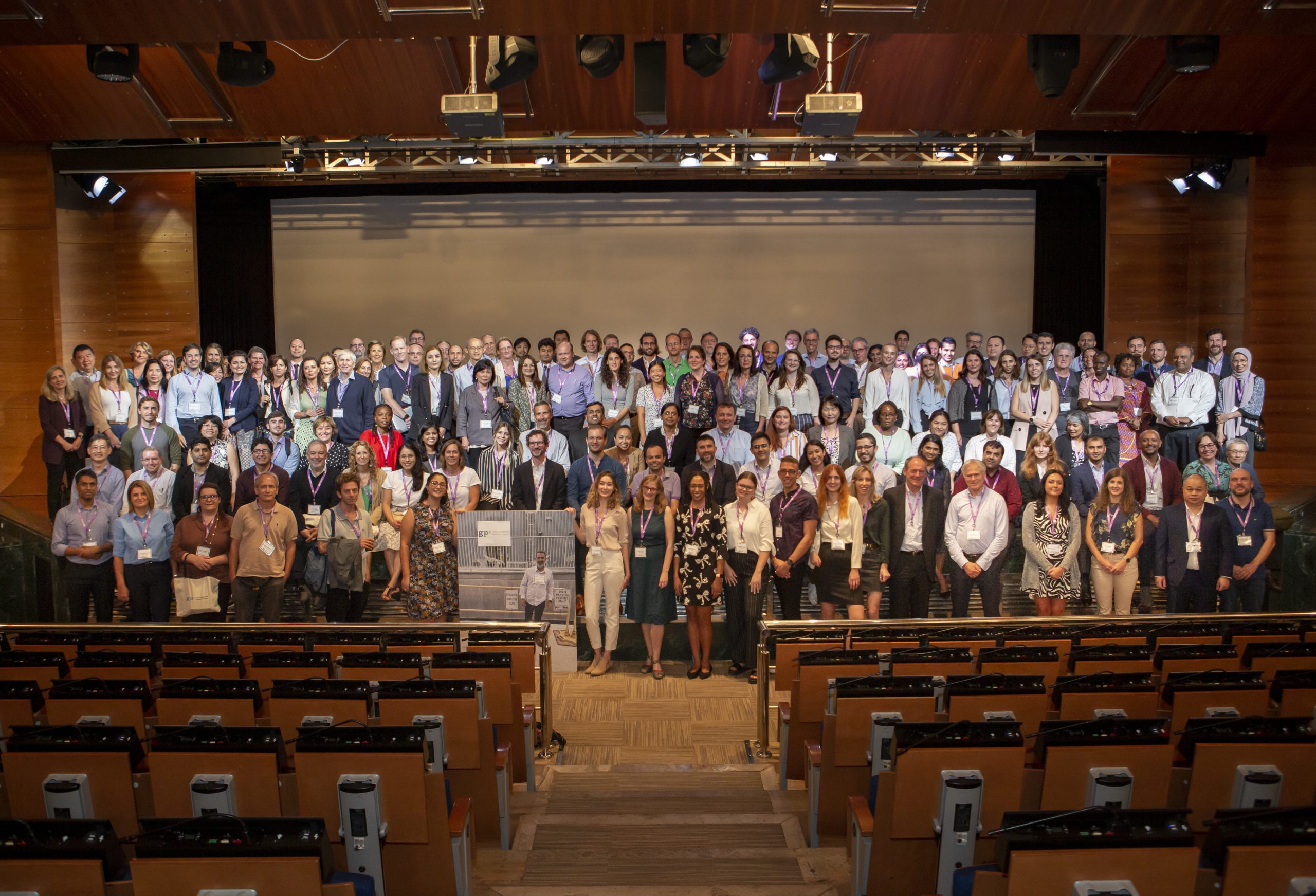 A group of attendees poses for a photo in front of the stage at GP2's first annual investigator's meeting.