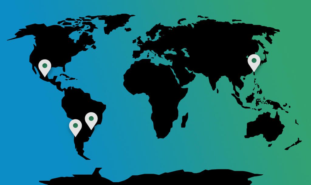 A world map with a blue-to-green gradient background and black continents. Four location markers are placed on the map: one in North America, one in South America, one in Southeast Asia, and one in East Asia. These markers indicate specific locations of interest, possibly related to a global program or initiative. The design is simple, with the focus on the marked locations.