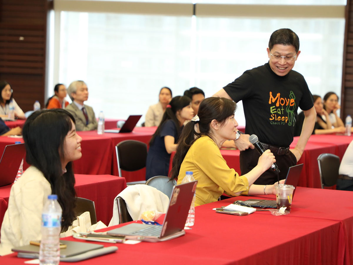 A researcher asks a question at a scientific presentation.